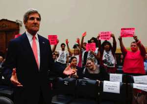 U.S. Secretary of State Kerry reacts as he waits for U.S. Secretary of Defense Hagel and General Dempsey to arrive at a U.S. House Foreign Affairs Committee hearing on Syria in Washington